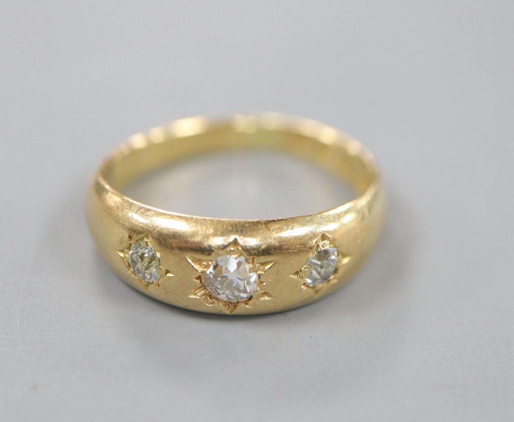 A Victorian 18ct gold and gypsy set three stone diamond ring, size O, gross 5.7 grams.